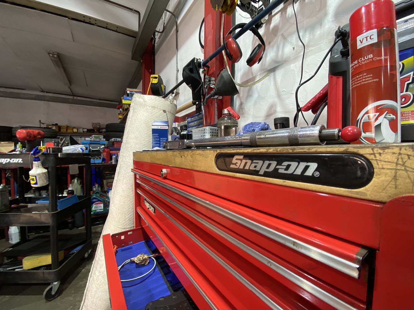 A car raised on the ramp inside the Mayday MOT and Service Centre workshop bay