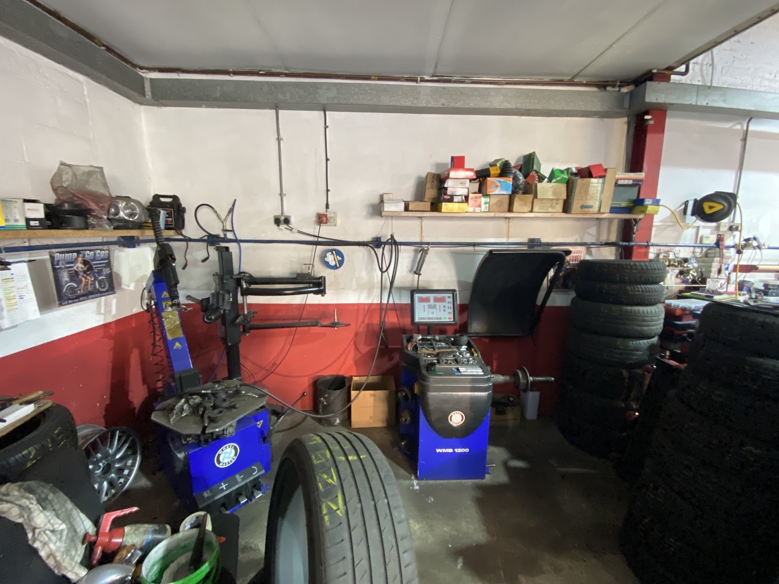 Mechanic working underneath a car on the ramp at Mayday MOT and Service Centre
